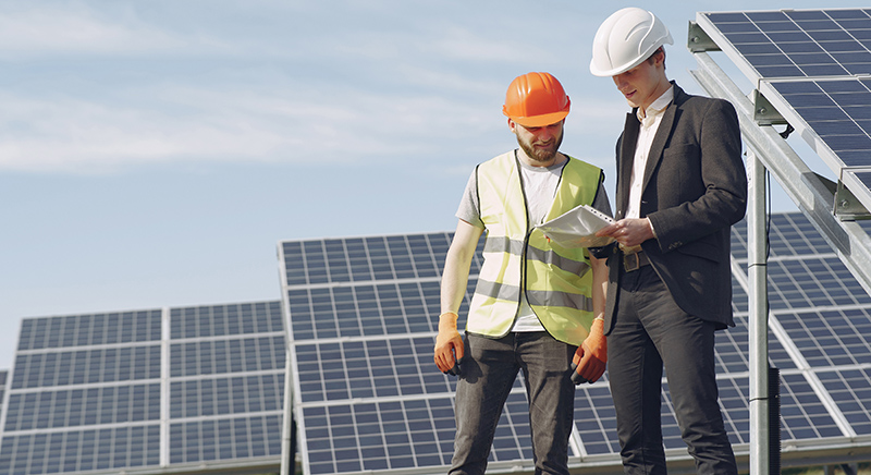 Foreman and businessman at solar energy station.
